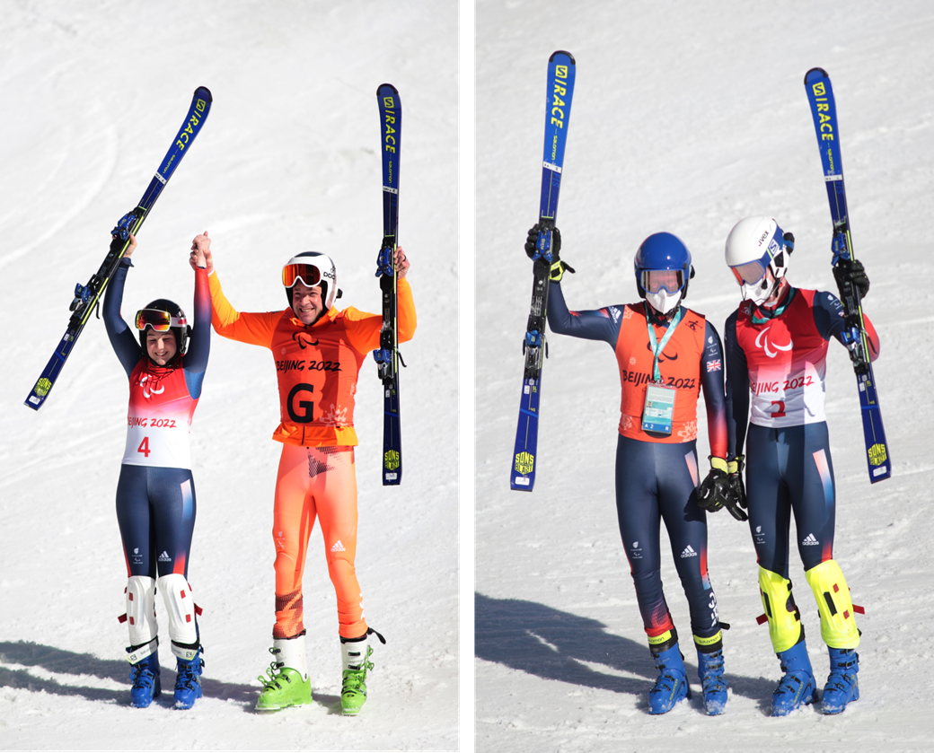 Fitzpatrick and Simpson with guides holding skis up and standing on snow